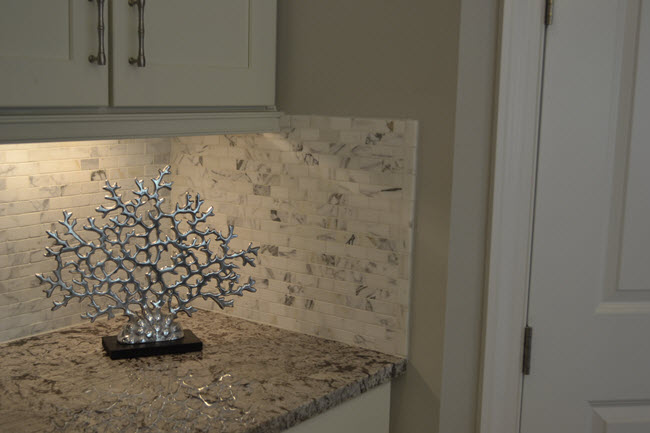 A 1x2 cararra polished marble backsplash